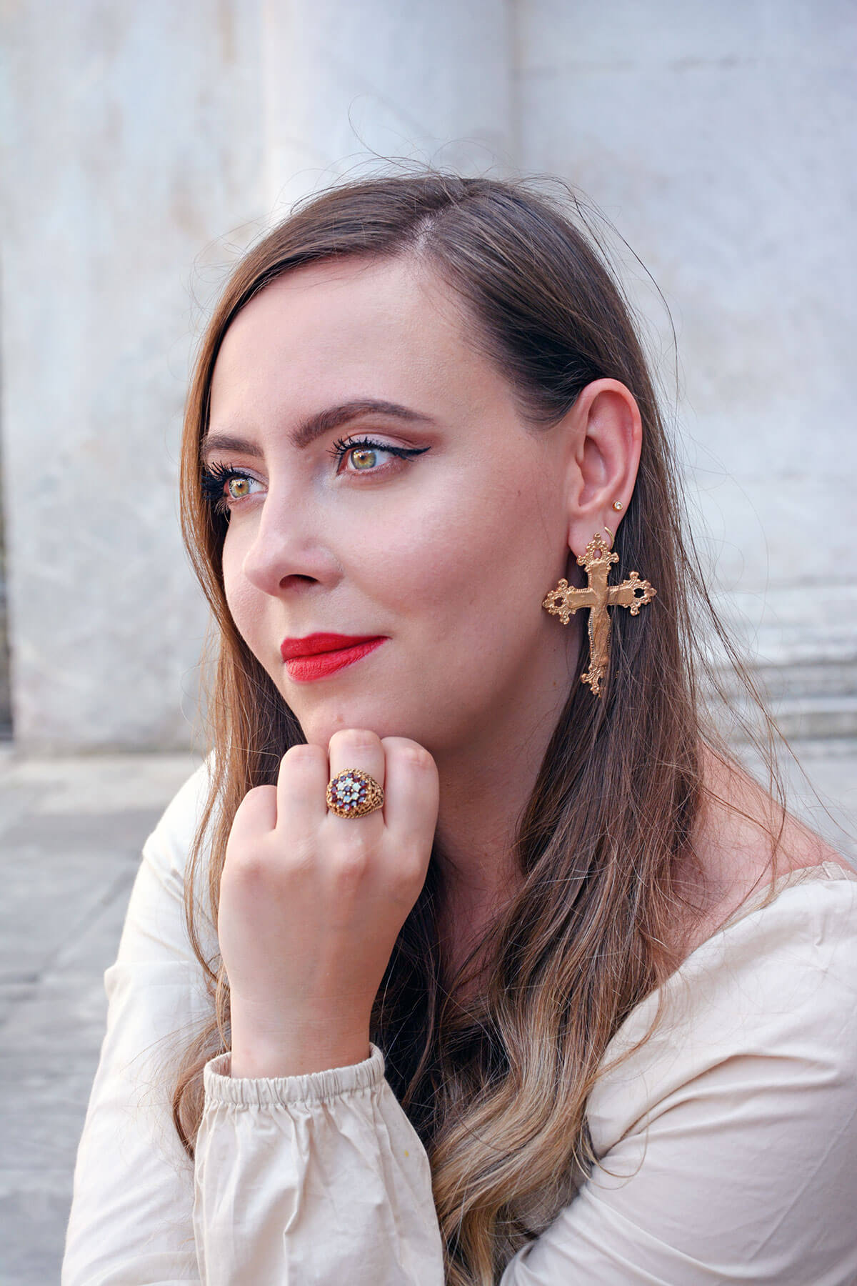 Jewellery influencer wearing cross earrings and rose gold jewellery