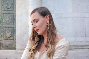 Jewellery influencer wearing cross earrings and rose gold jewellery
