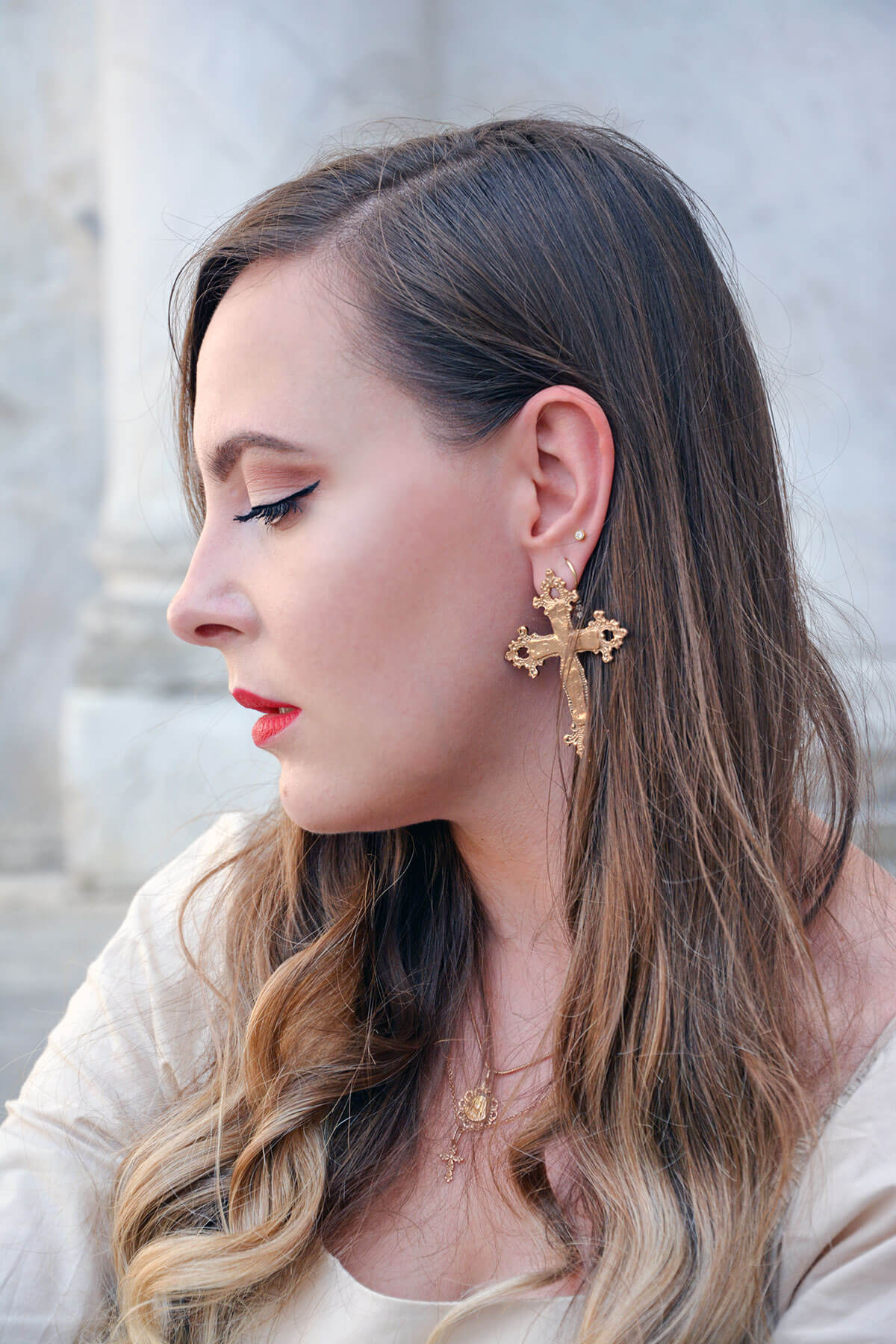 Edita in Lucca Tuscany wearing Cross earrings and rose gold jewellery 9