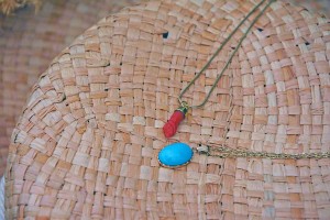 Influencer in Asos, antique figa pendant, emerald jewellery, turquoise pendant