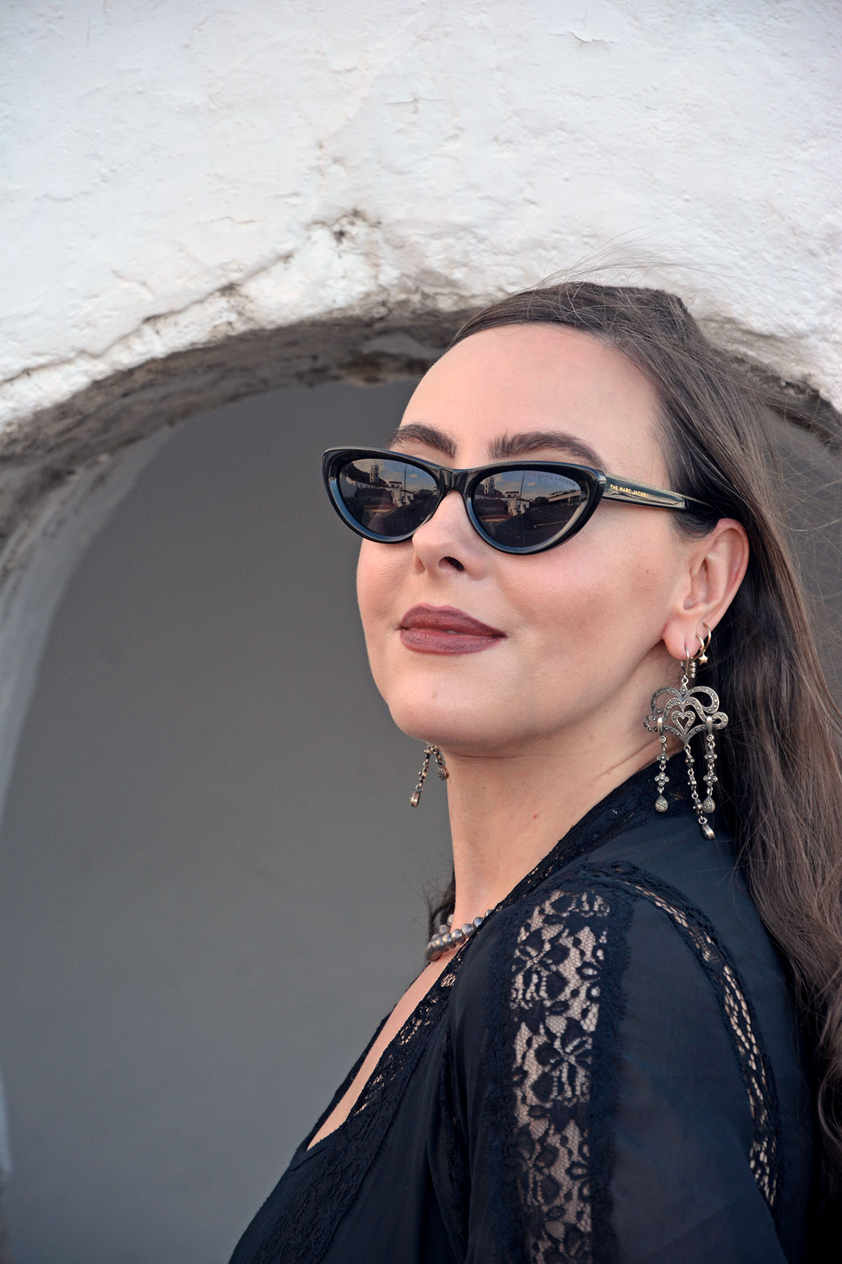 Content creator in silver earrings and silver bead necklace in Tenerife