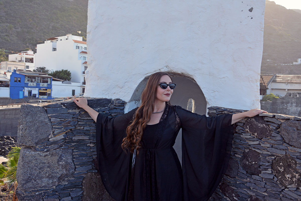 Content creator in silver earrings and silver bead necklace in Tenerife