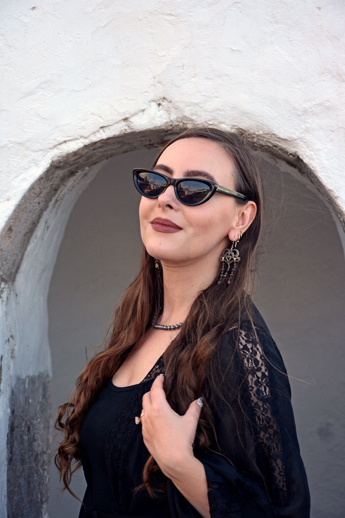 Content creator in silver earrings and silver bead necklace in Tenerife
