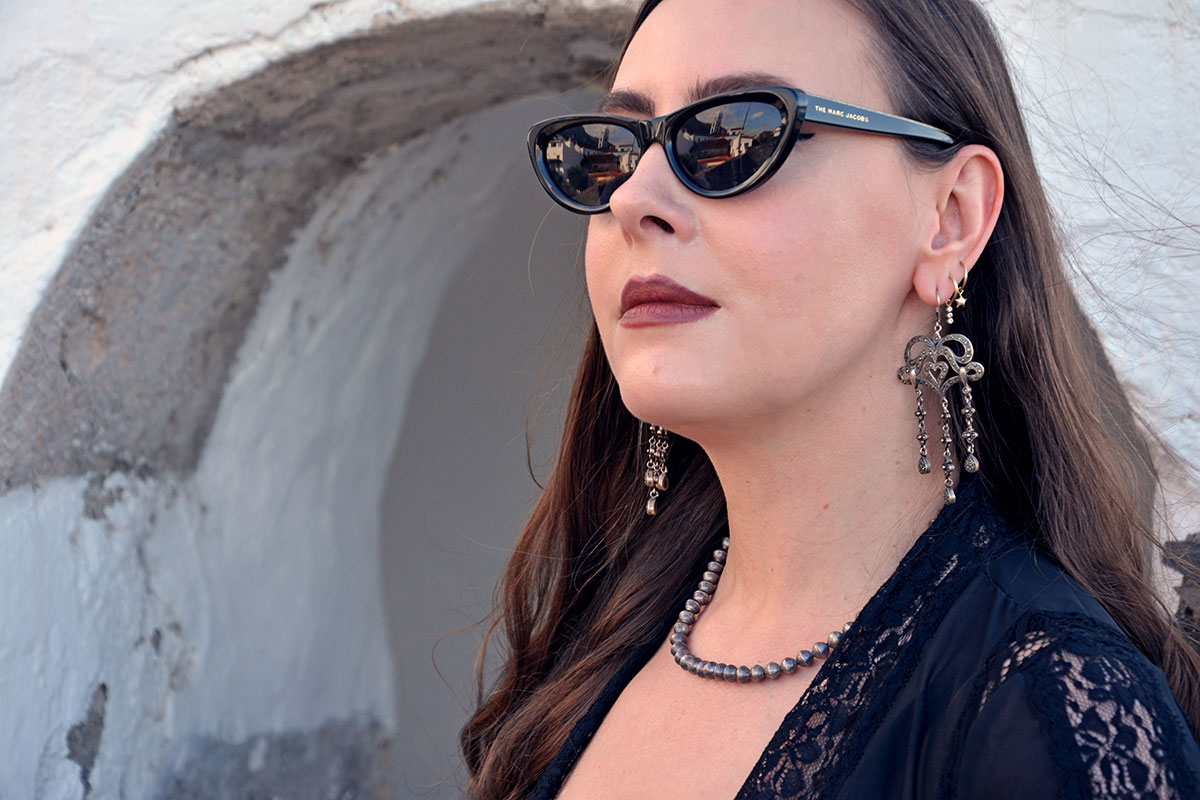 Content creator in silver earrings and silver bead necklace in Tenerife