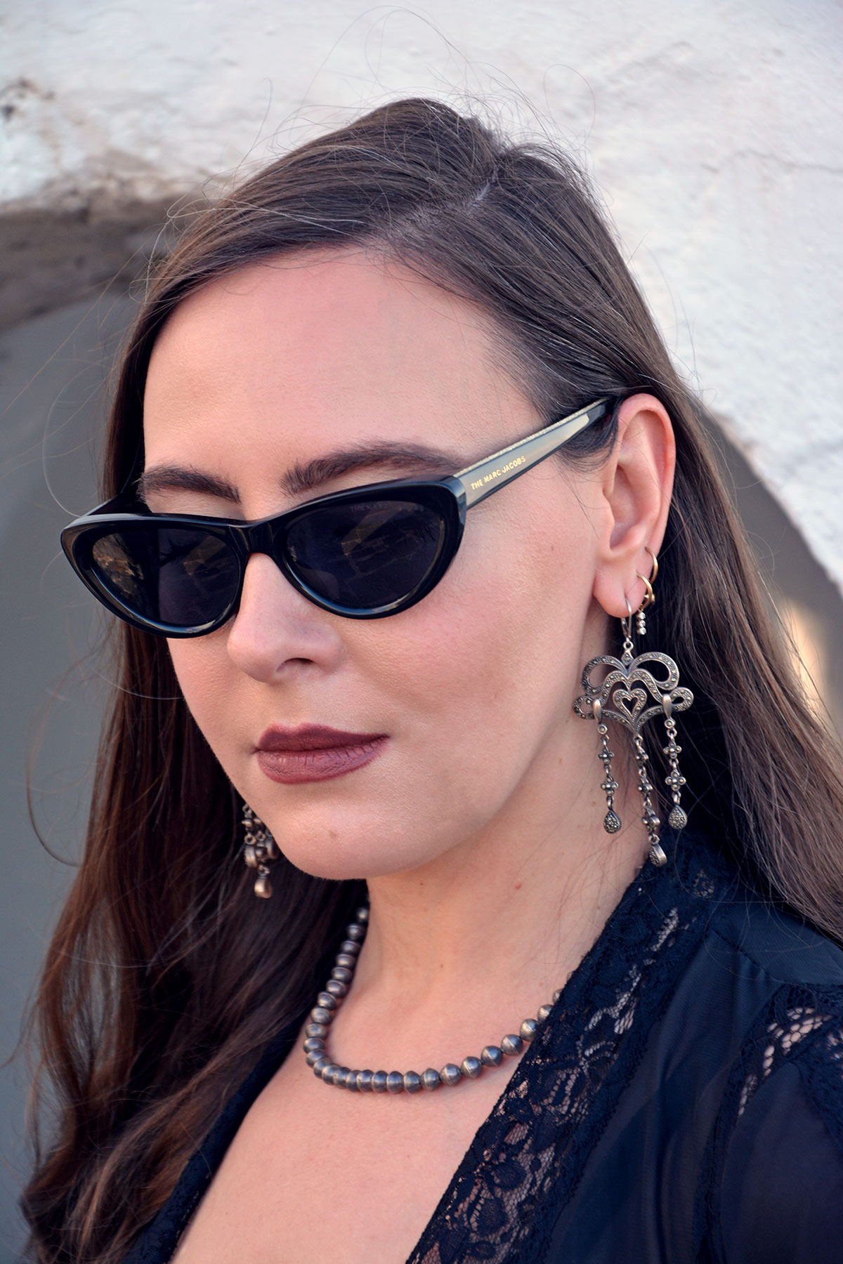 Content creator in silver earrings and silver bead necklace in Tenerife