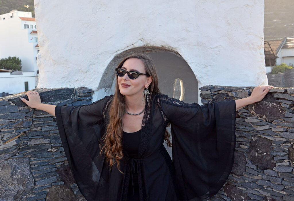Content creator in silver earrings and silver bead necklace in Tenerife