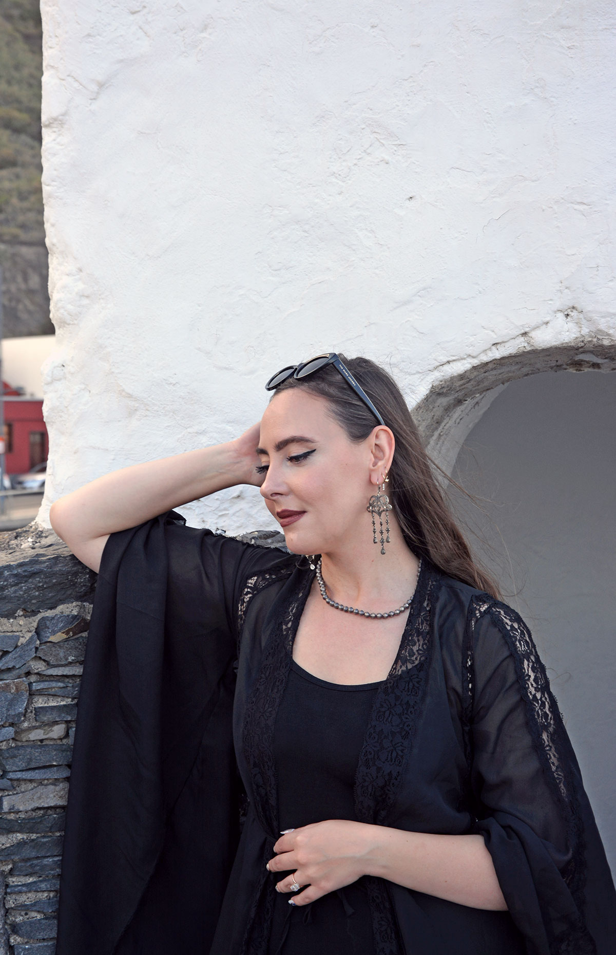 Content creator in silver earrings and silver bead necklace in Tenerife