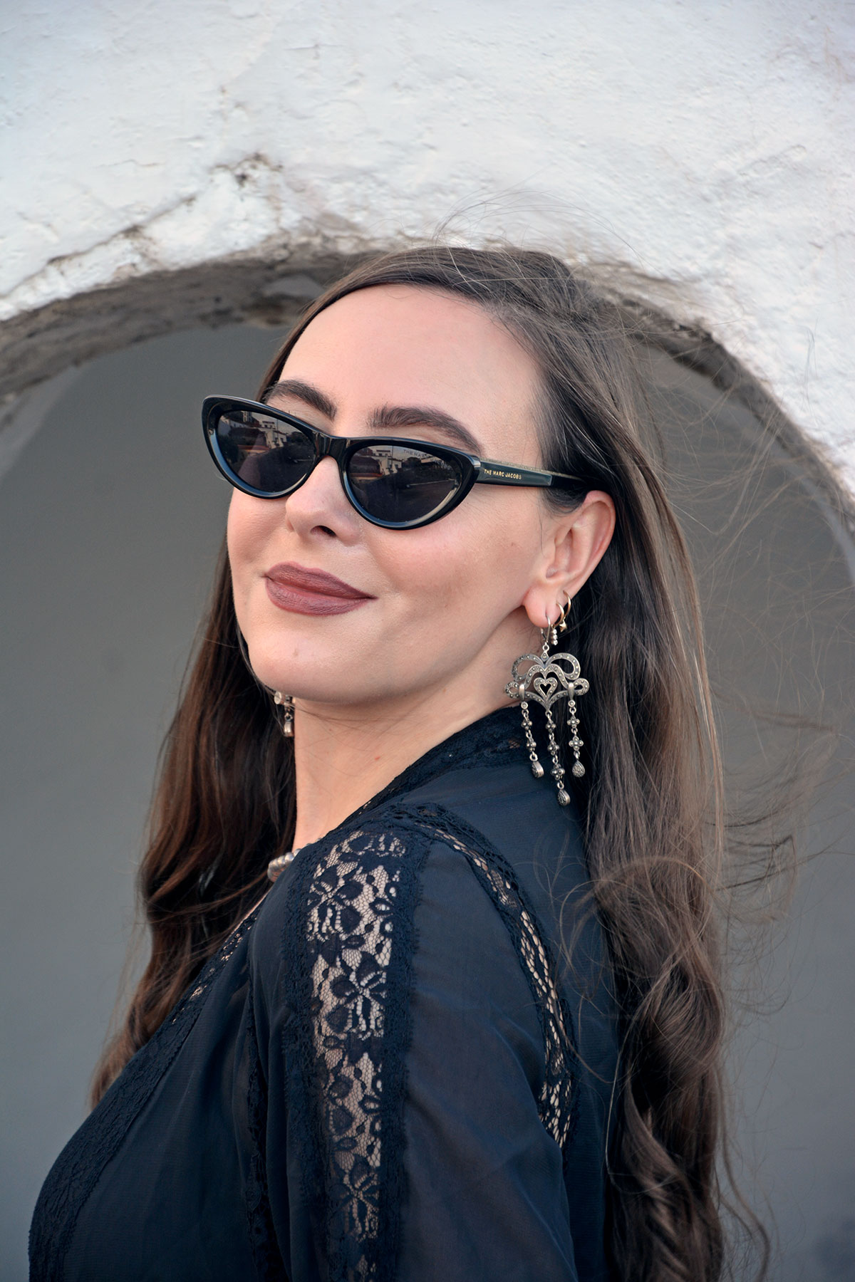 Content creator in silver earrings and silver bead necklace in Tenerife