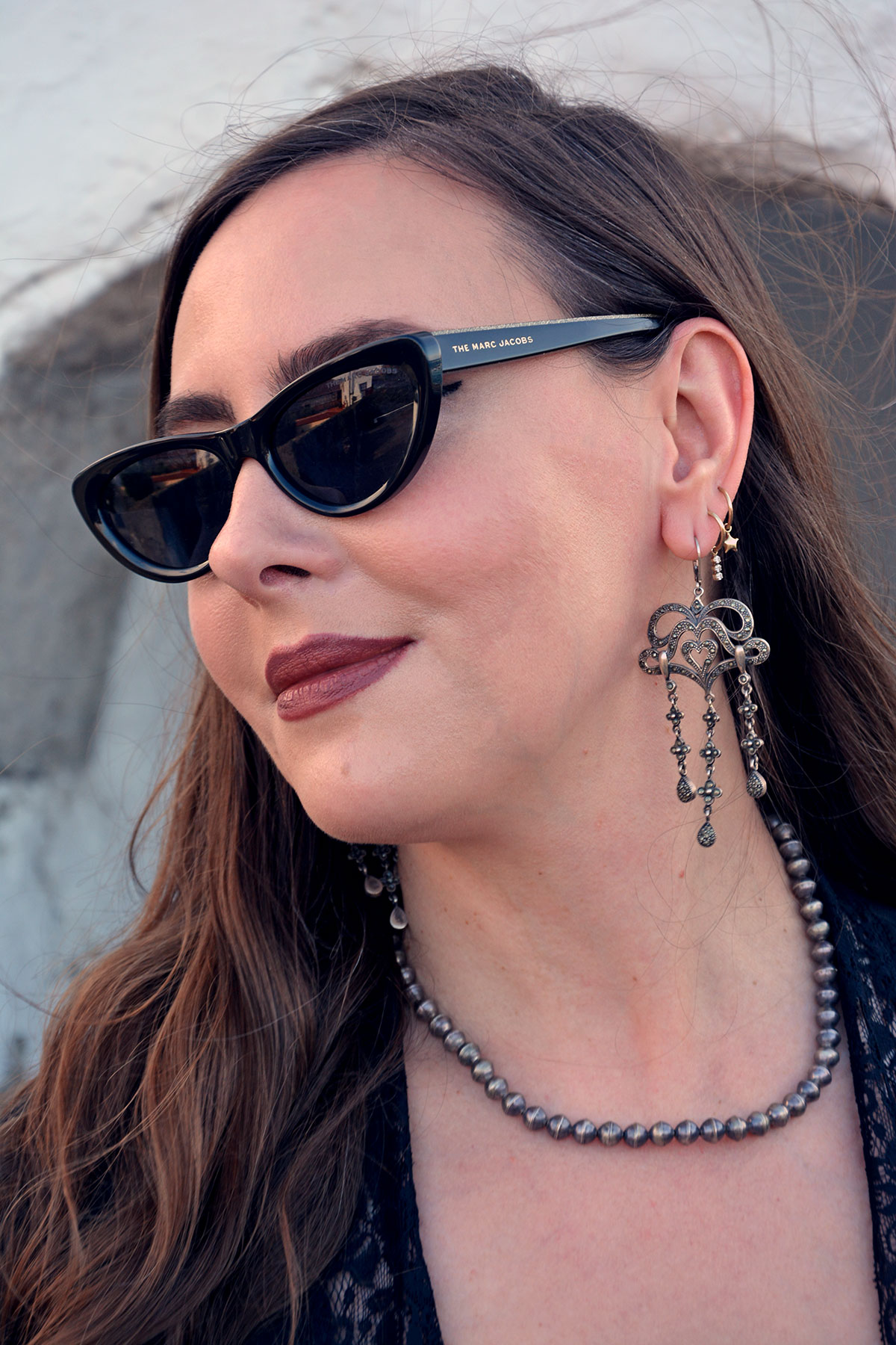 Content creator in silver earrings and silver bead necklace in Tenerife